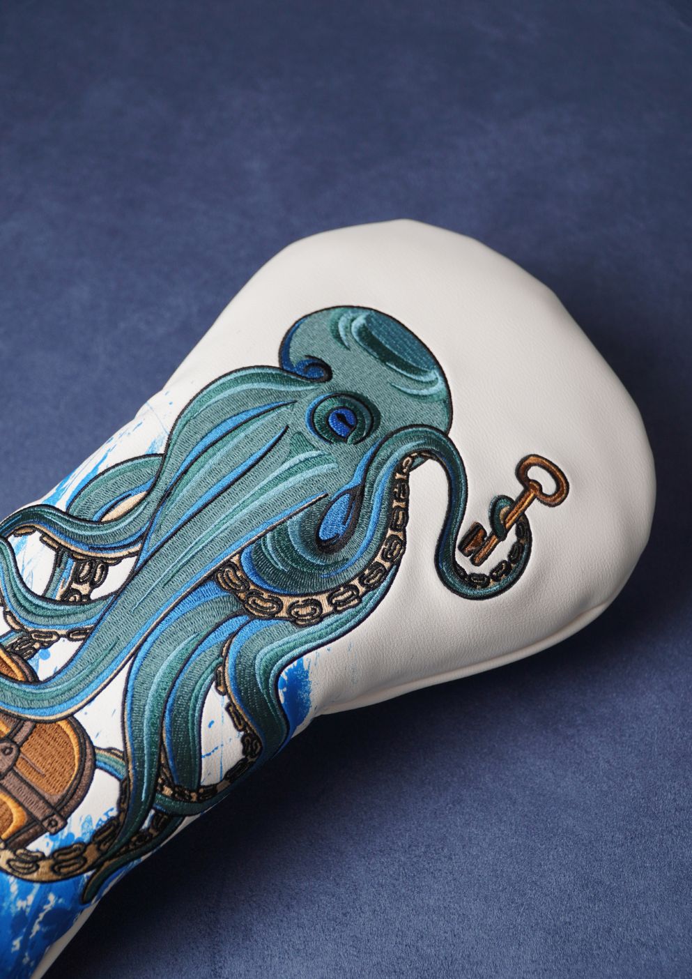 Decorative golf head cover with an octopus design on a blue background