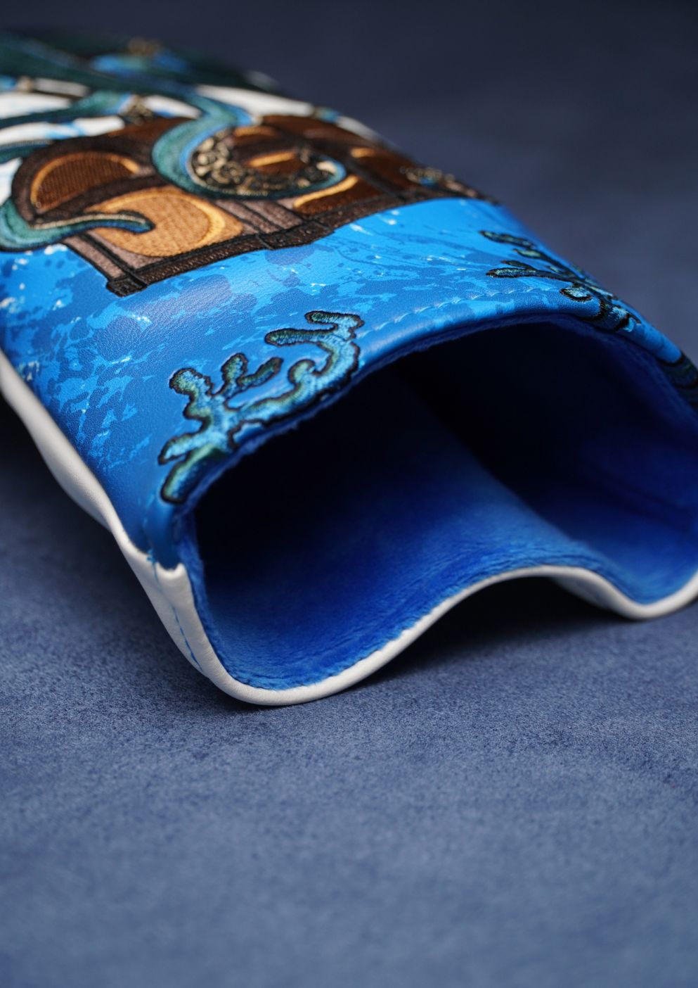 Close-up of a blue golf headcover on a dark blue background