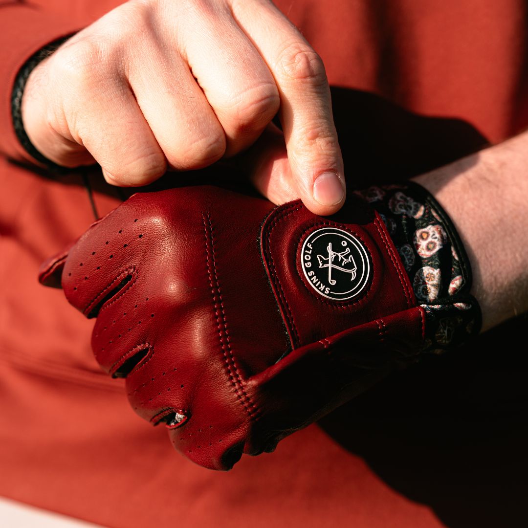brown leather golf glove with black skull design