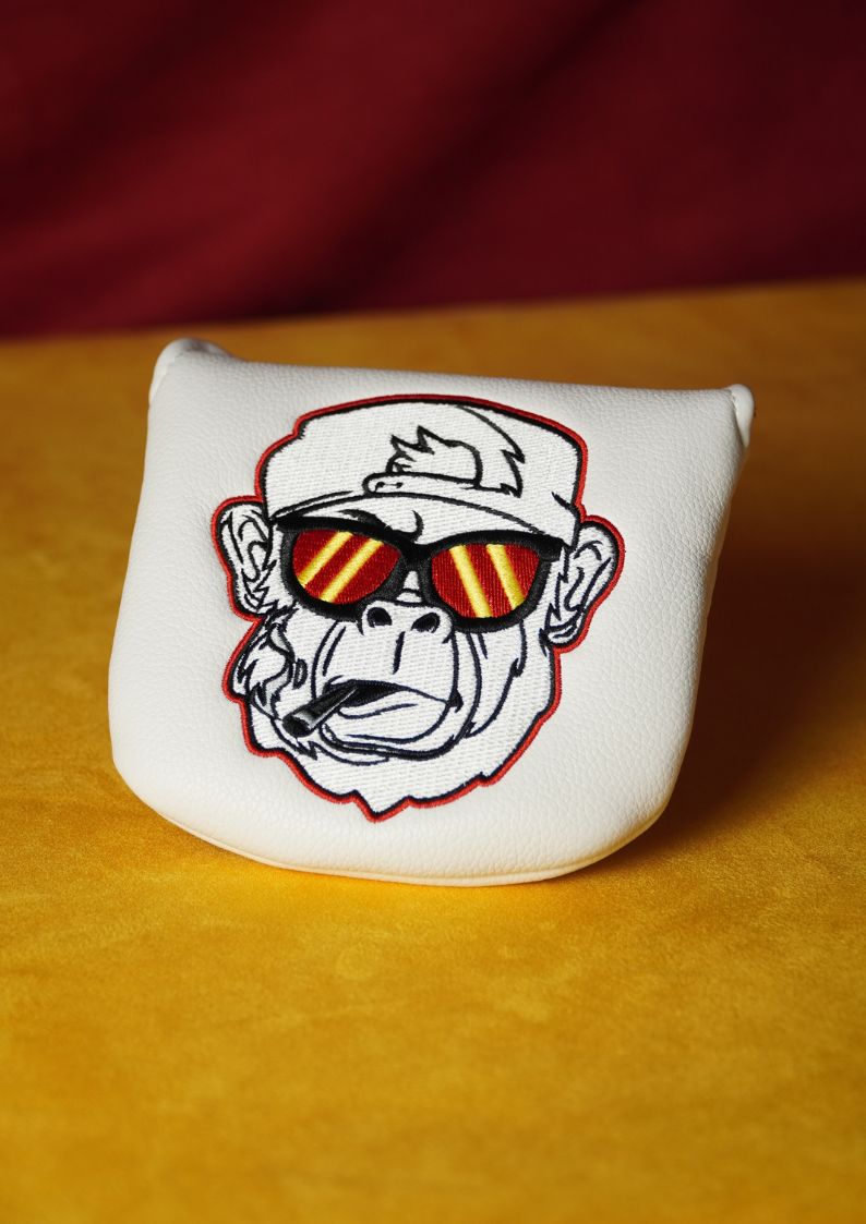 White mallet putter cover featuring a gorilla wearing sunglasses on a yellow surface