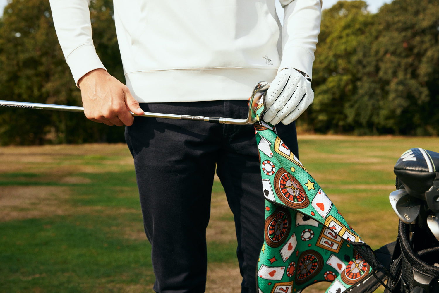 Golfer cleaning casino themed golf towel