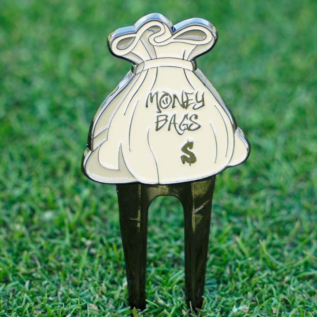 golf divot tool with money bags design
