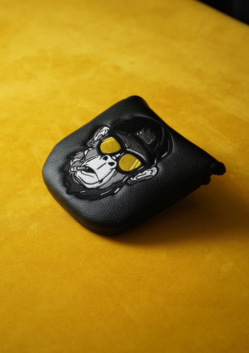 Black leather golf headcover with a gorilla design on a yellow background