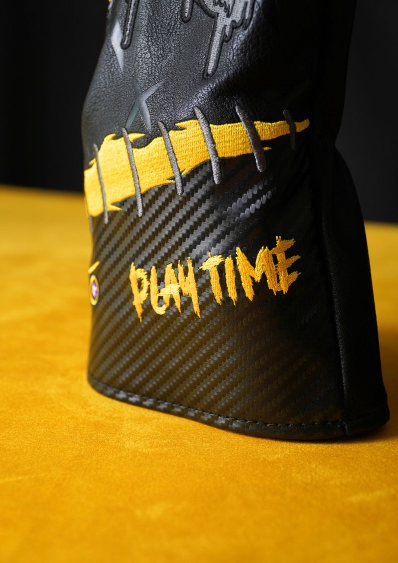 Black and yellow golf club head cover with 'Play Time' text on a yellow background
