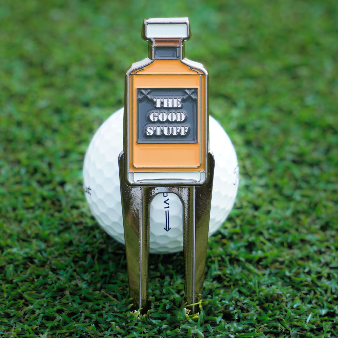 golf divot tool with whiskey design