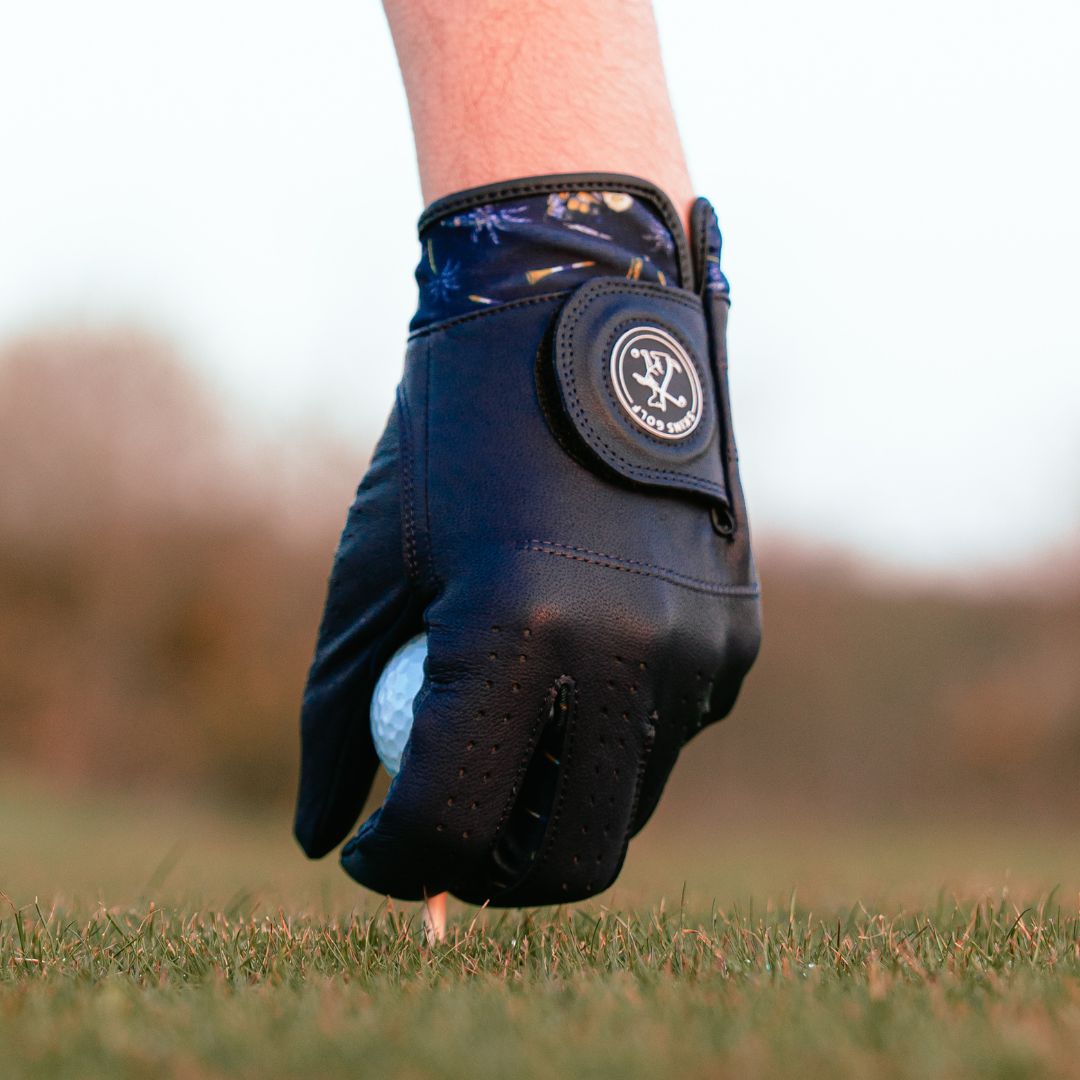 Navy Golf glove on a golf ball with a blurred background
