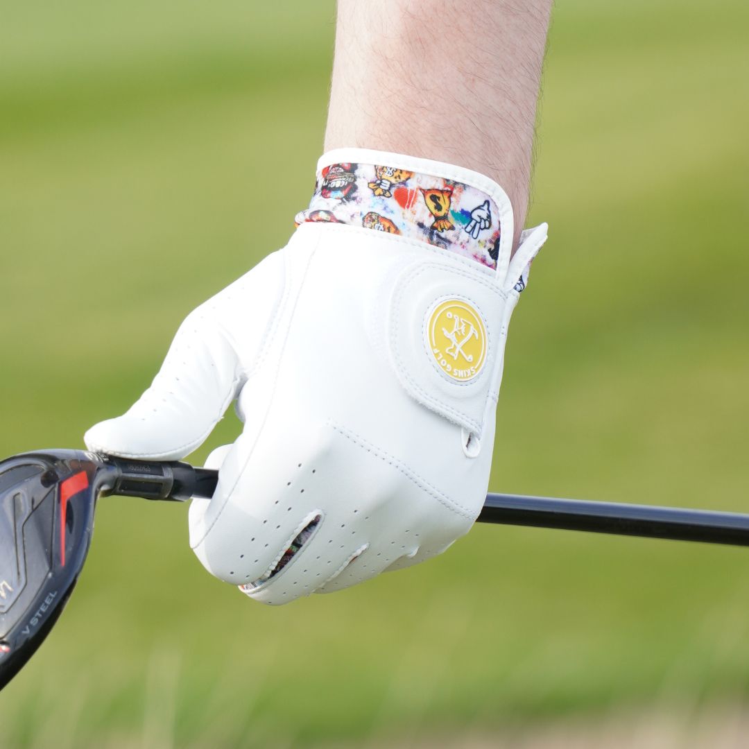 Golf glove on a golf club with a colorful bandage on a blurred green background