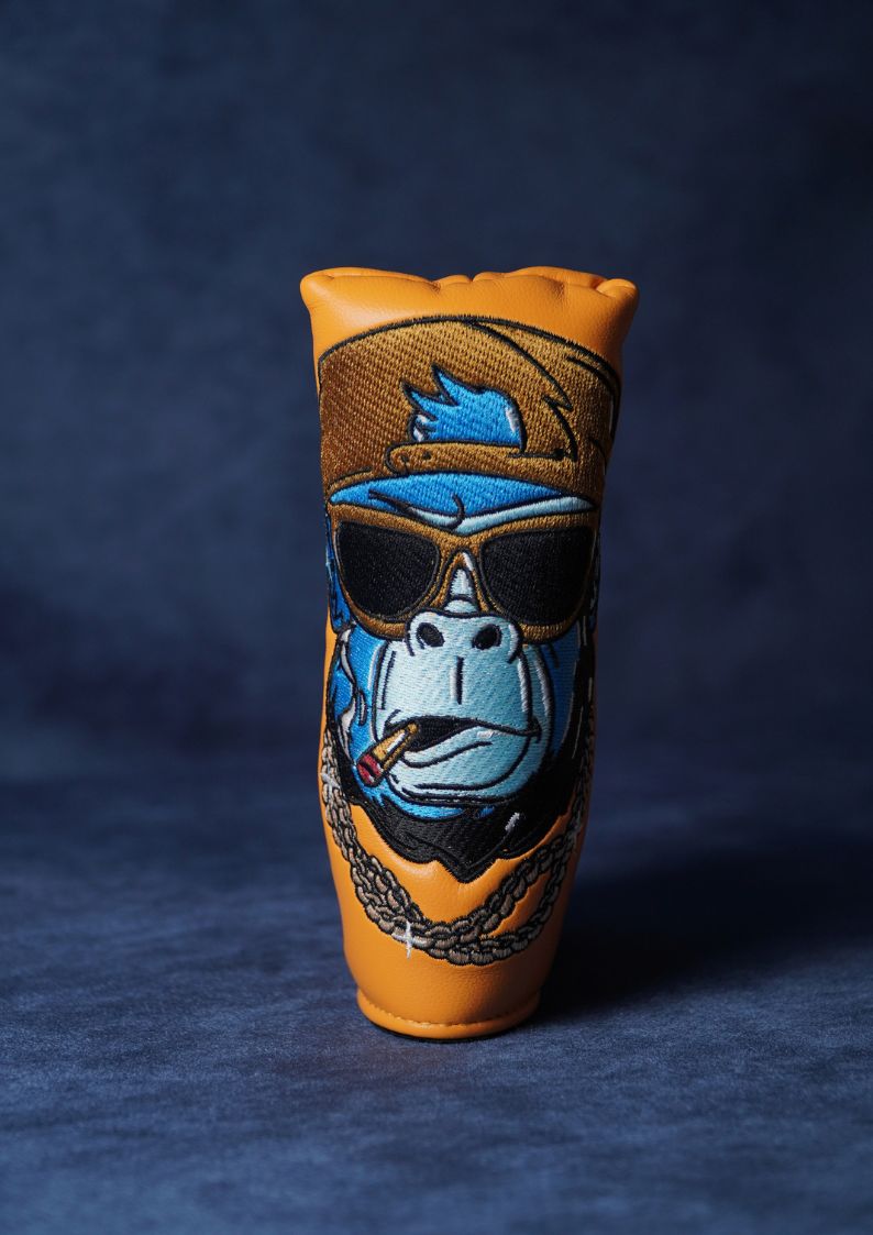 Leather blade headcover for golf with a stylized gorilla design on a dark blue background
