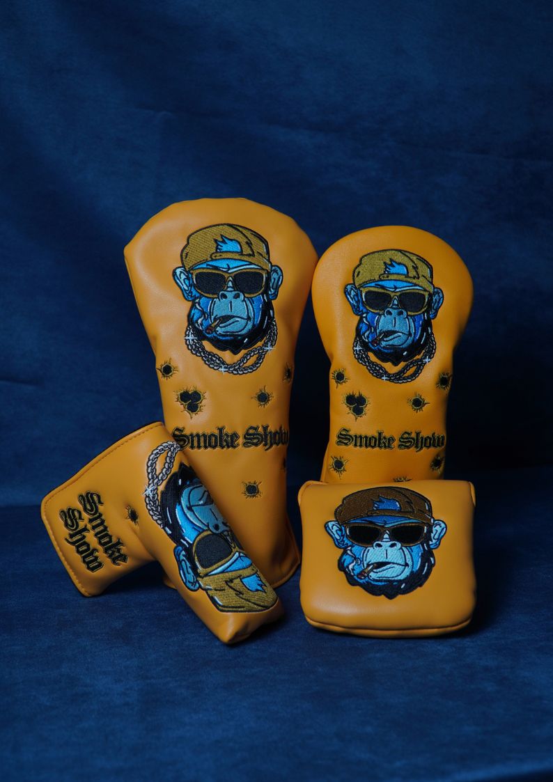 Set of golf club head covers with monkey design on a blue background