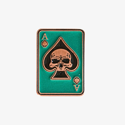Golf ball marker with ace of spades design on a green background
