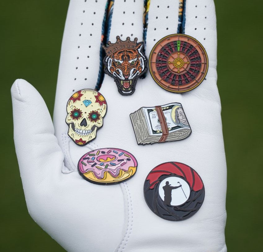Cool golf ball markers on a glove