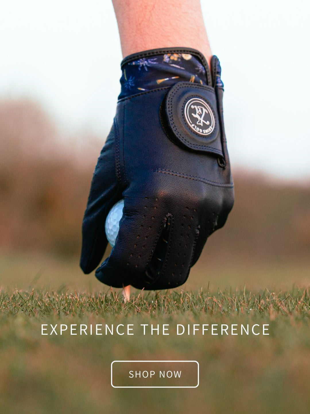 Golf glove holding a golf ball with 'Experience the Difference' text and 'Shop Now' button on a blurred grass background
