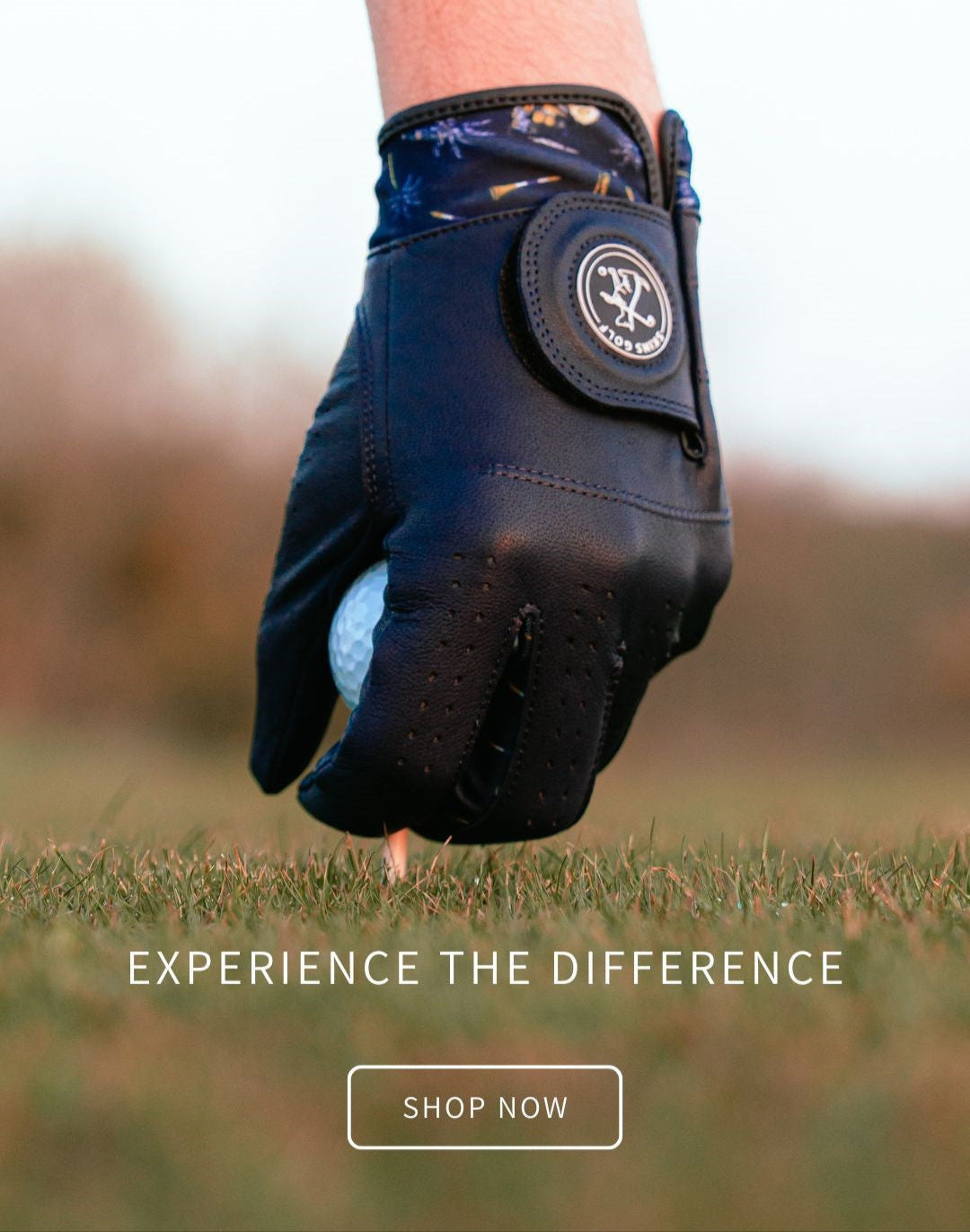 Golf glove holding a golf ball with 'Experience the Difference' text and 'Shop Now' button on a blurred grass background