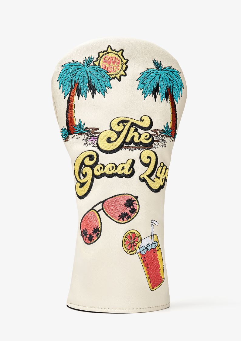 Golf club head cover with 'The Good Life' text and tropical designs on a white background