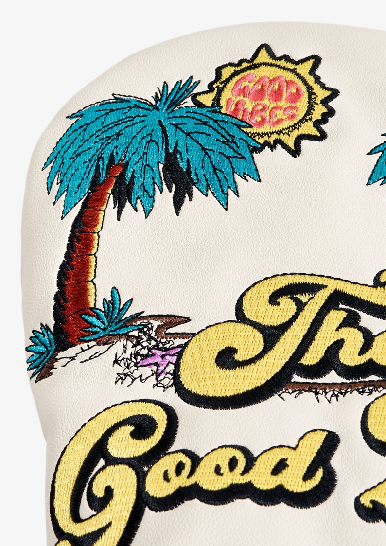 Embroidered golf club headcover design with palm tree, sun, and text on a white background