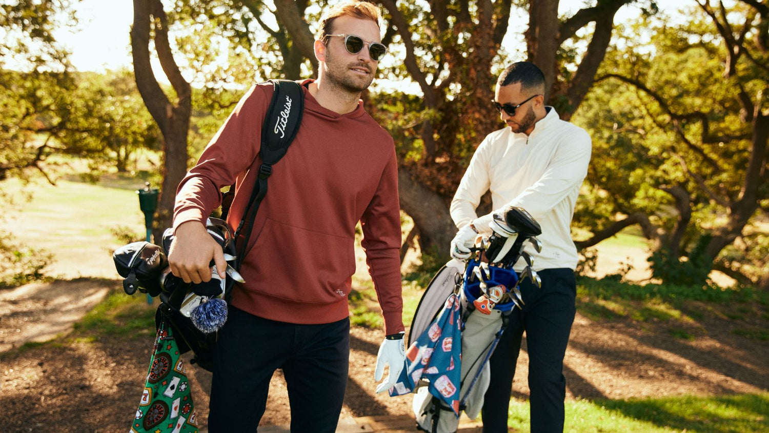 Golfers wearing cool gear and carrying golf bags