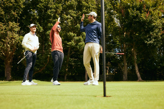 Golfers wearing golf apparel celebrating