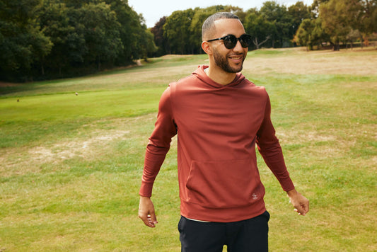 Golfer wearing a coloured golf hoodie
