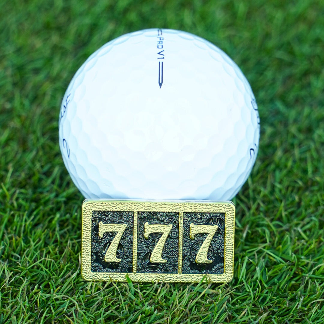 golf ball marker with 777 in gold