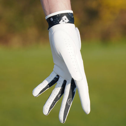 White golf glove with black accents on a blurred green background