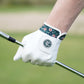 White golf glove with floral wristband on a blurred green background