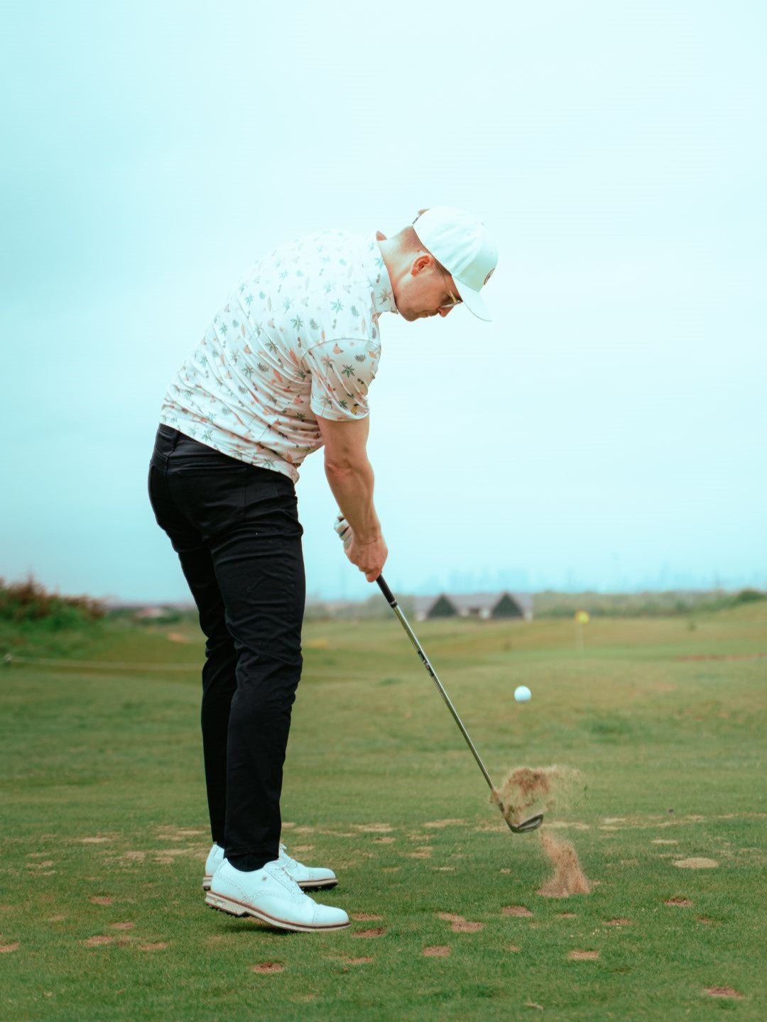 golfer hitting shot wearing polo
