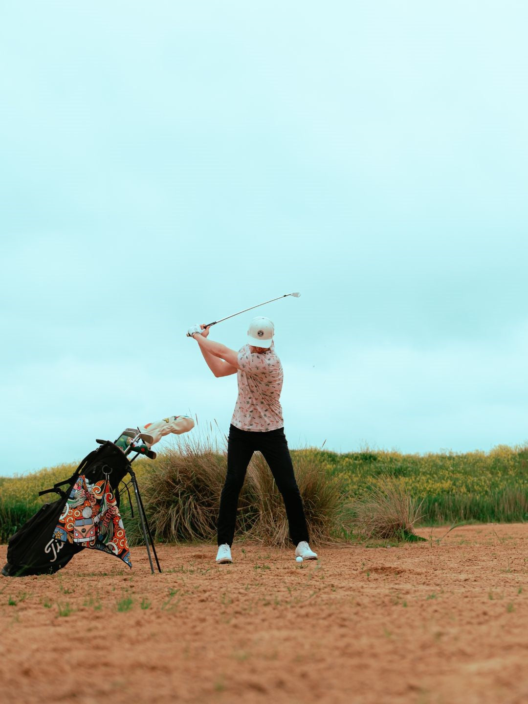 golfer taking a shot wearing tropical polo