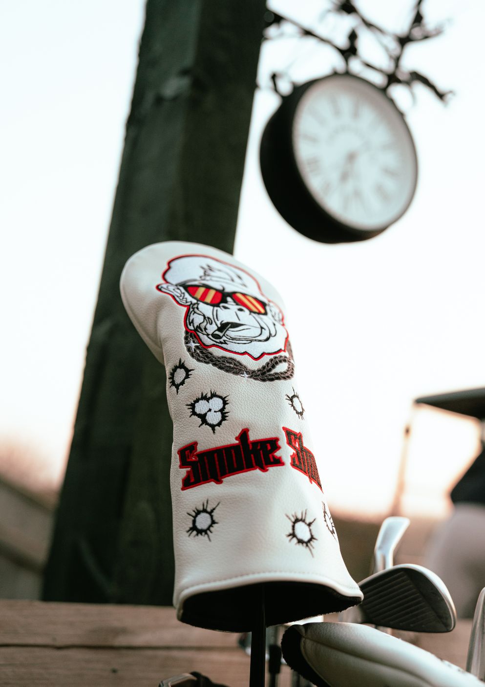 Golf club head cover with gorilla character design on a blurred background