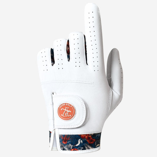 White golf glove with floral pattern on the wristband on a light gray background
