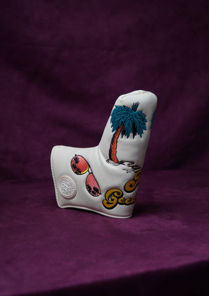 White golf club head cover with palm tree design on a purple background
