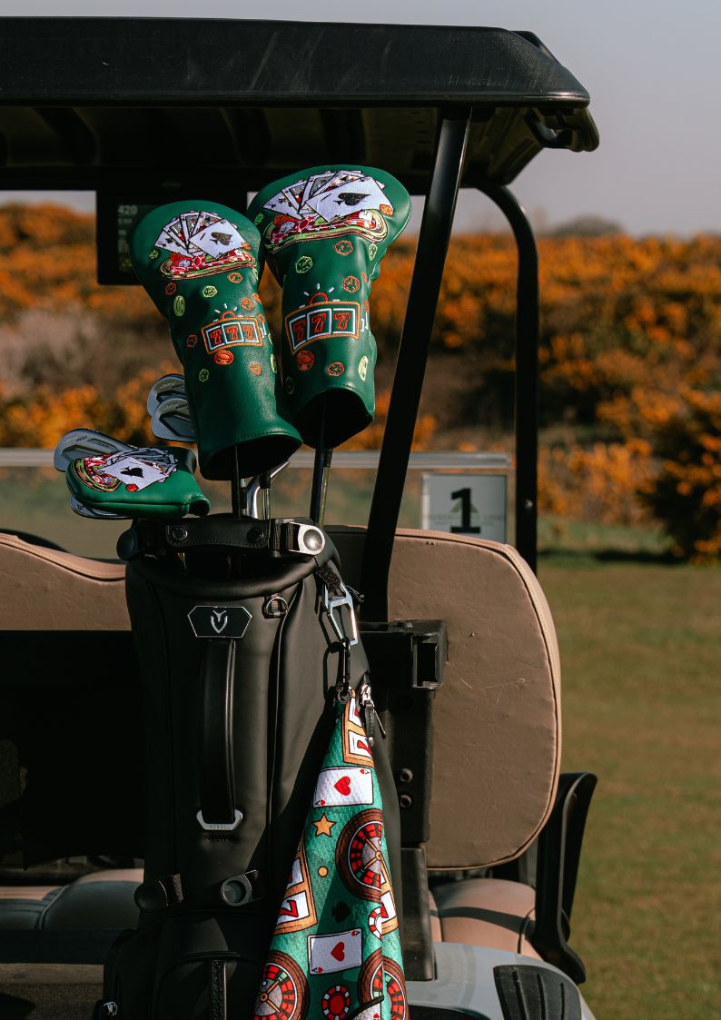 Golf club covers with casino designs on a golf cart