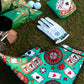 Casino-themed golf bag, gloves, and accessories on grass