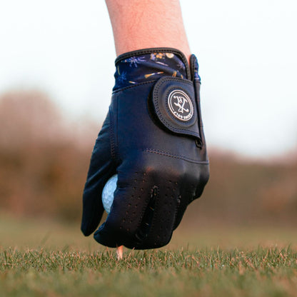 Navy Golf glove on a golf ball with a blurred background