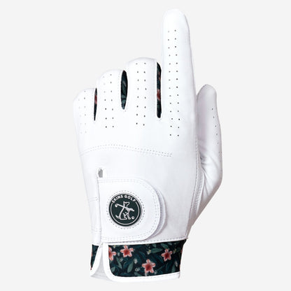 A white golf glove with a floral patterned cuff and a circular logo patch on the back of the hand, shown against a light gray background.