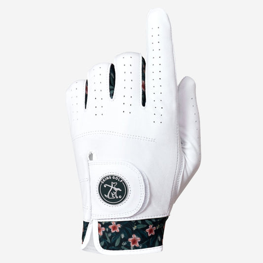 A white golf glove with a floral patterned cuff and a circular logo patch on the back of the hand, shown against a light gray background.