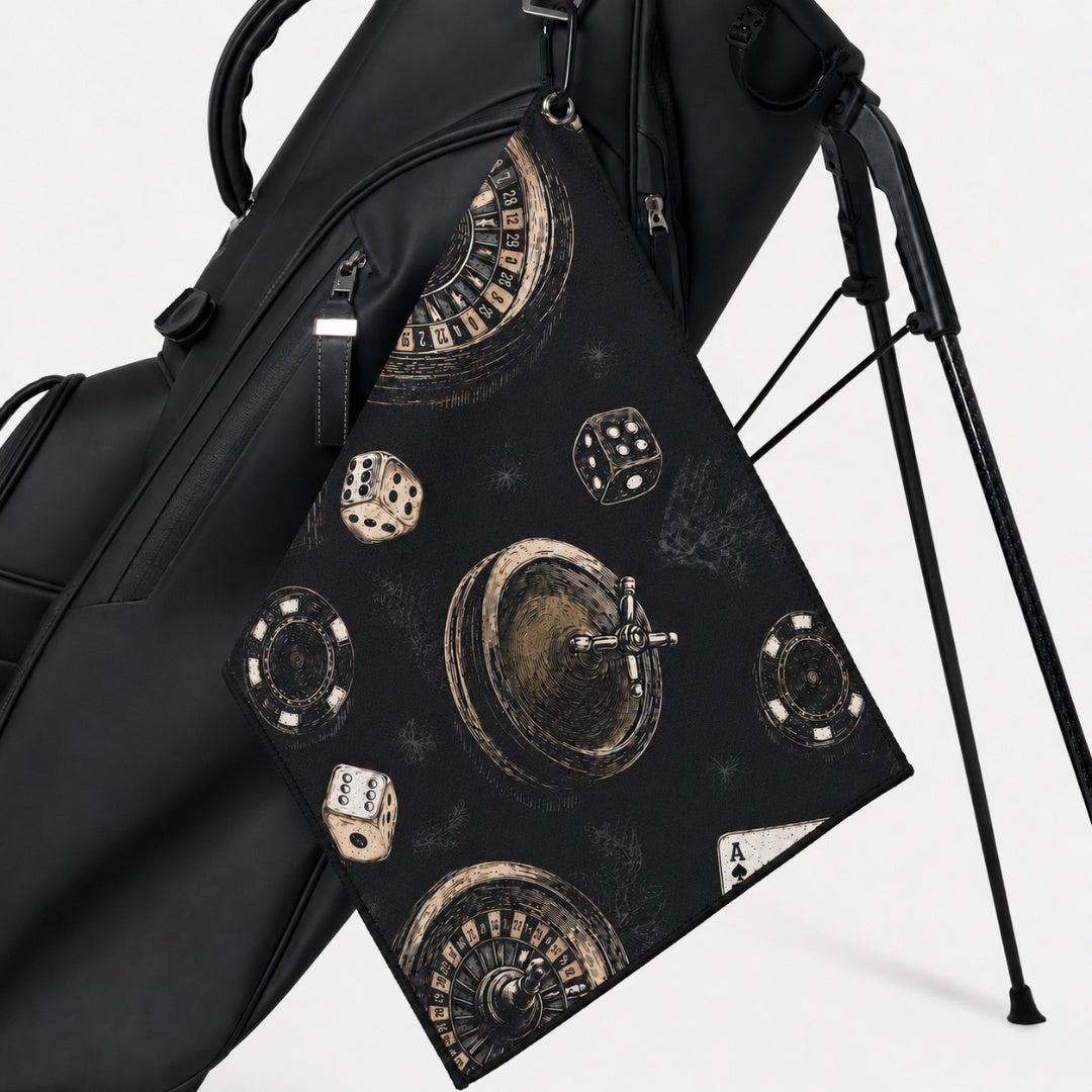 Black golf bag with decorative towel featuring dice and roulette design on a white background