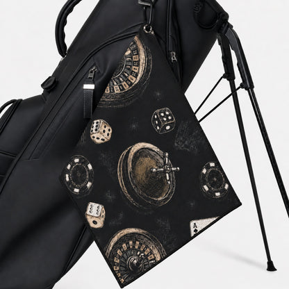 Black golf bag with decorative towel featuring dice and roulette design on a white background