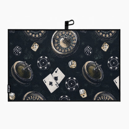Casino-themed golf towel with roulette, dice, cards, and chips on a dark background