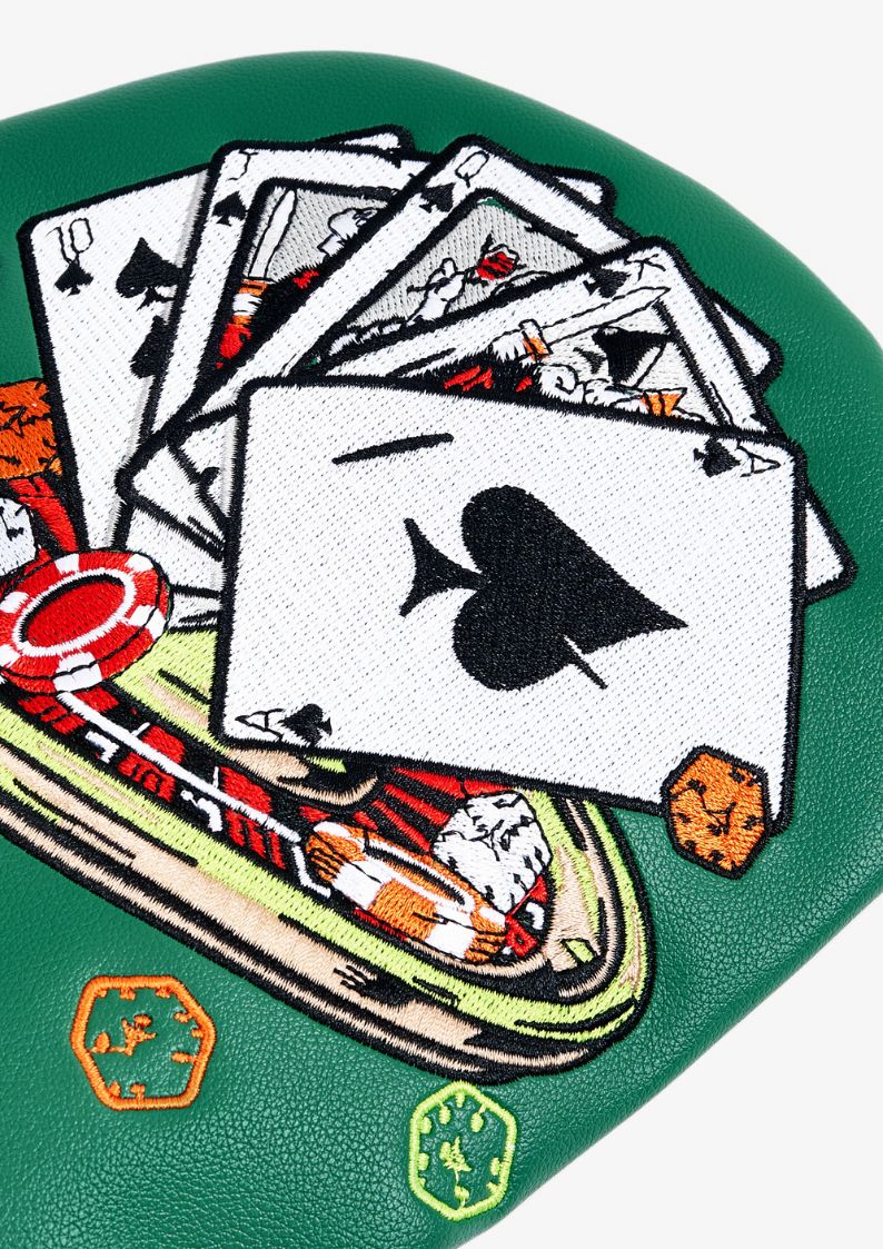 Embroidered golf headcover design of playing cards, poker chips, and aces on a green background