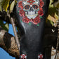 Black leather golf club head cover with skull and rose design on a natural background