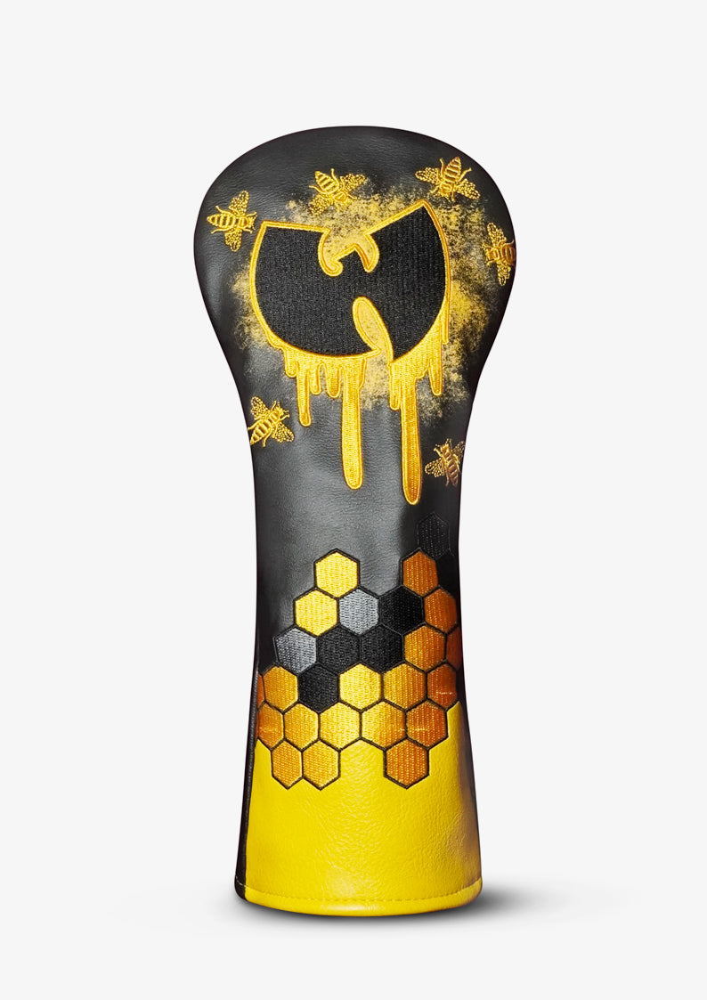 A golf club headcover featuring a black and gold Wu-Tang Clan-inspired design with a dripping logo, honeycomb pattern, and bee motifs, shown on a light gray background.