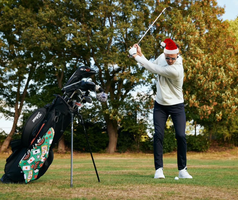 golfer playing shot with Christmas hat on