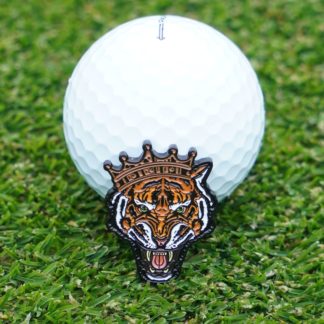 Golf ball marker with a tiger wearing a crown