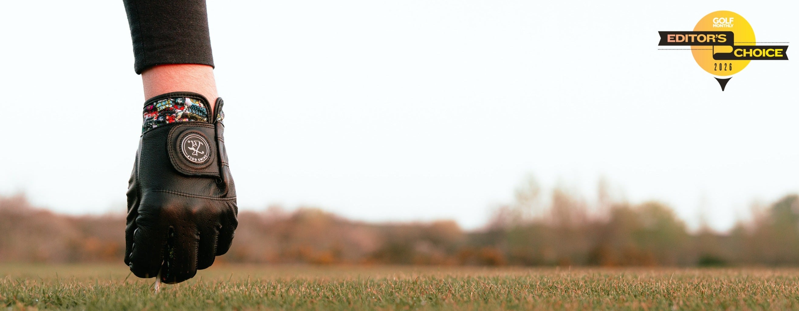 Black Golf glove teeing up ball