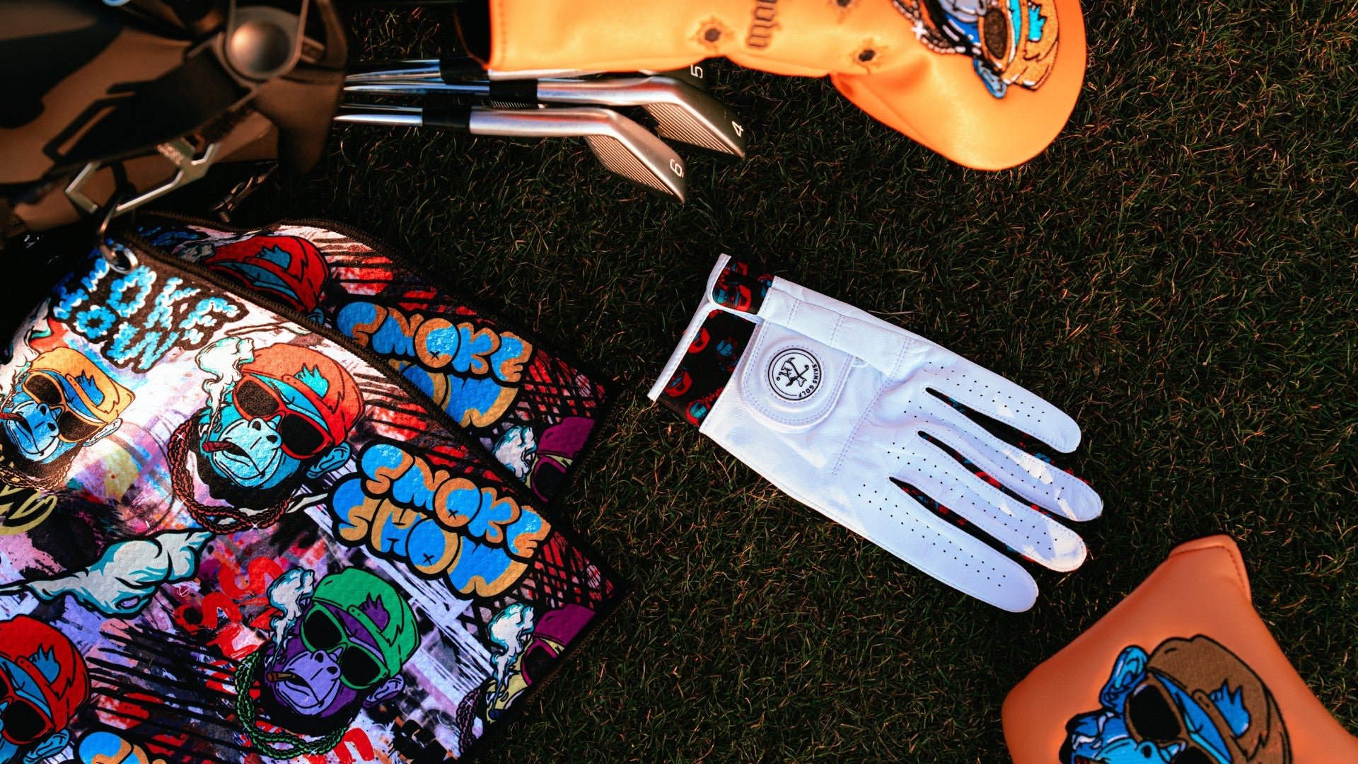 Unique golf accessories and golf gifts on a green.