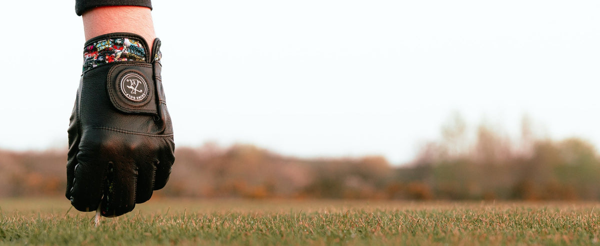 Golf glove placing ball on ground