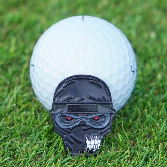 Golf ball with a ninja ball marker on grass