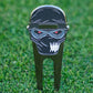 Golf divot tool with ninja design on grass
