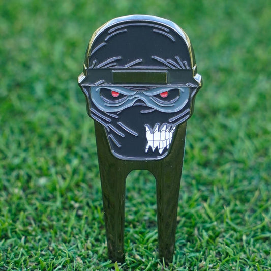 Golf divot tool with ninja design on grass