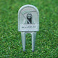 Golf divot tool with grim reaper design and 'MAKE IT' text on grass